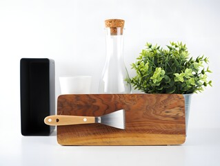 Still life showcases kitchen tools and decor against a bright white background space