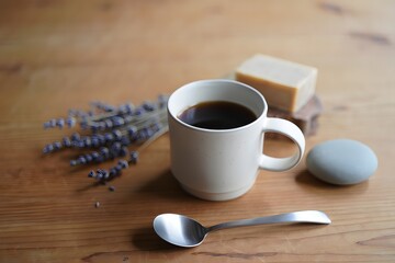 Still life with coffee and lavender on a wooden surface in a calm setting scene