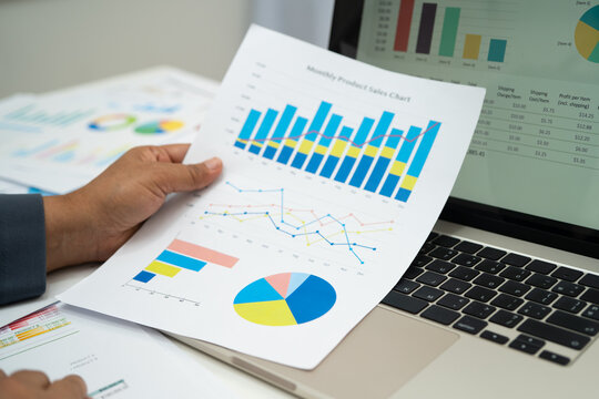 Asian business woman working with financial graph.