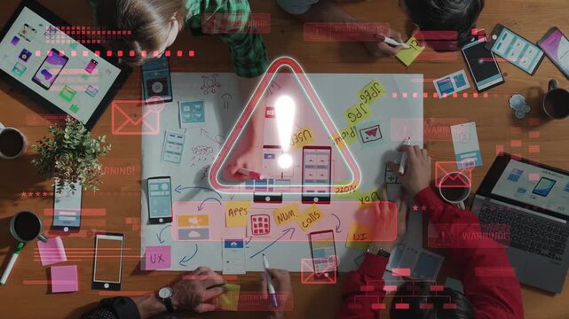 A vibrant workspace shows a collaborative session focused on app design. Participants engage with sketches and devices to enhance user experience and gather feedback. Raster