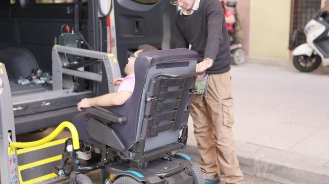 Person with physical disability using accessible van lift
