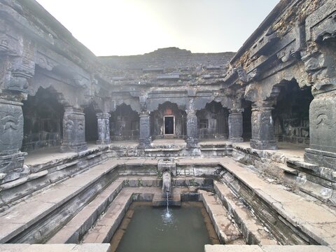 Ancient Krishnai Temple in Mahabaleshwar showcasing the sacred origin of the Krishna River, with stone pillars, carved architecture, stepped platforms and the historic gomukh spring flowing.