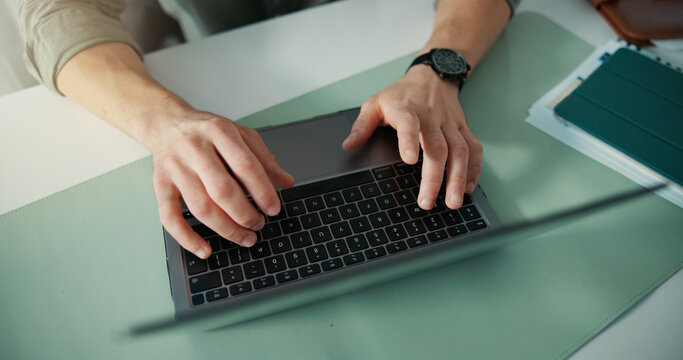 Top view, typing or hands in office with laptop, research or online communication on email app. Keyboard, person or employee in agency with tech, internet search or connection on digital platform. - Powered by Adobe