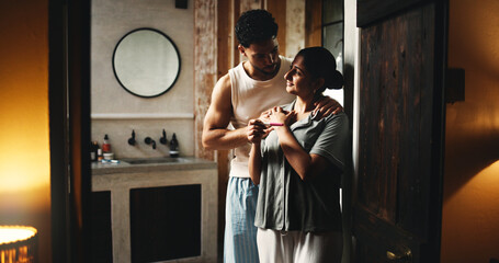 Door, hug and pregnancy test with couple in bathroom together for family planning or fertility. Pregnant, results and stick with happy people in dark apartment for love, parenthood or support