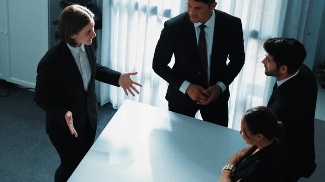 Top view of project manager looking at meeting table surrounded by diverse business people brainstorm and planning strategy. Group of smart people discussing and solve business problems. Directorate. - Powered by Adobe