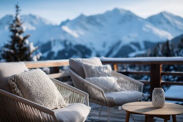 Fototapeta premium Comfortable chairs and lantern on a winter balcony overlooking scenic snowy mountains, offering a tranquil retreat.