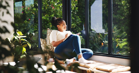 Happy, woman and thinking with notebook, window and writer with ideas for novel or planning in home. Creative, author and black person with journal for story, reflection and smile for remote work