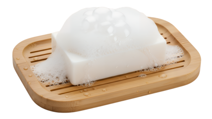 Foamy white bar of soap with abundant bubbles on a wooden dish, representing cleanliness and hygiene, studio shot isolated on transparent background