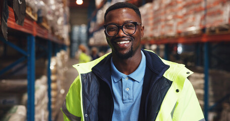 Portrait, black man and smile for logistics in warehouse with career pride, transport stock and...