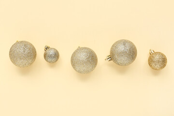 Beautiful composition with golden Christmas balls on beige background