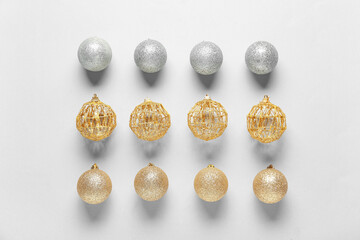 Beautiful composition with silver and golden Christmas balls on white background