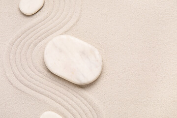 Composition with stones and lines on sand as background, closeup. Zen concept