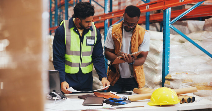 Business people, laptop and notebook in warehouse for logistics, meeting for supply chain collaboration. Import team, tech and documents in storage facility for export, delivery service or supplier