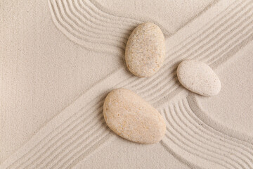 Naklejka premium Composition with spa stones and lines on sand as background, closeup. Zen concept