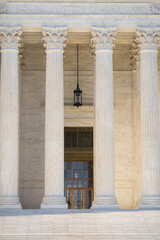 Fototapeta premium Historic government architecture with marble pillars. White stone columns shaping civic architecture. Court house exterior with classical design. Monumental columns emphasizing historic architecture.