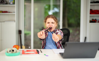 Kid on online lesson in home school. Child learning knowledge through homeschooling and online classes. Young student focused on virtual lesson at home school desk. Boy studying mathematics online.