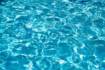 Ripped water in swimming pool. Surface of blue swimming pool, background of water.