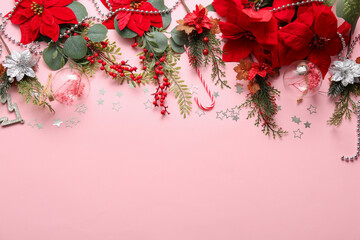 Composition with Christmas poinsettia flowers and decorations on pink background