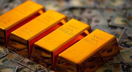Gold bars and money. Shiny golden bars stacked with US dollars in background. Gold bars for secure capital growth. Dollars money and gold concept. Financial success and saving Gold.