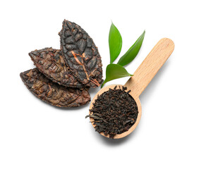Dry pressed puer tea in shape of leaves with wooden scoop on white background