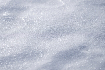 Frozen snow field in natural light. White snow backdrop with cold pattern. Minimal clean winter background. Frozen surface with snow and frost texture.