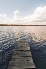 Fototapeta premium Tranquil lake with trees and blue sky