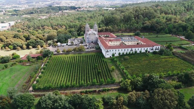 aerial shot of the benedictine monastery of tibaes and green rural landscape