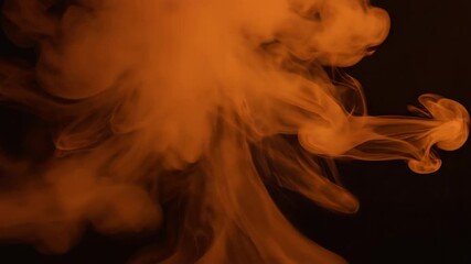 Vertical video of orange smoke rising against a black background. Abstract fluid motion of a billowing vapor cloud. Dynamic visual effect for creative projects - Powered by Adobe