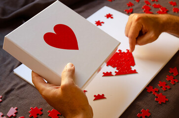 Creative love symbol made from puzzle pieces, captured in warm light, ideal for concepts of romance, teamwork, and meaningful relationships.