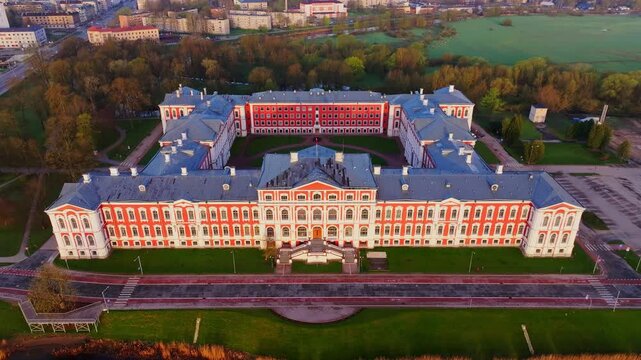 Historic Elegant Baroque Jelgava Palace glowing under sunrise from drone above