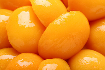 Texture of sweet canned peaches as background