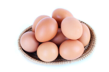 Chicken eggs stacked in a small woven basket top View, white background, clear and minimal style.