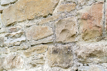 Textured stone wall showcases rustic charm and craftsmanship in a tranquil outdoor setting