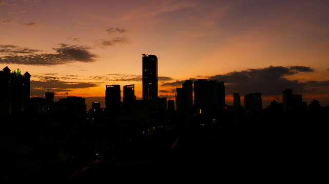 Sunset over the city of Phnom Penh, silhouette of the skyscraper when the sun down 