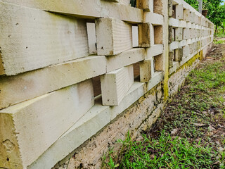 Textured white concrete block wall with geometric openings