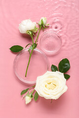 Composition with white rose flowers and Petri dishes in water on pink background