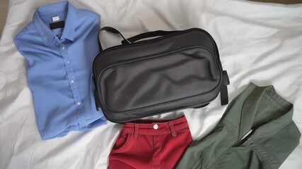 Unpacking essentials get ready for travel with a sleek black bag on soft white bedding anticipating adventure and restful moments ahead