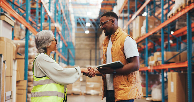 Warehouse, handshake and people with tablet for logistics, distribution and agreement with supplier. Happy, team and shaking hands for success in factory, supply chain and celebration with gesture