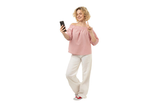 Happy woman using a smartphone standing, isolated on white, PNG - Powered by Adobe