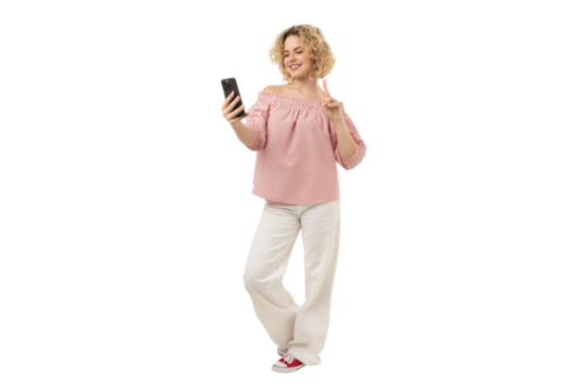 Happy woman using a smartphone standing, isolated on white, PNG