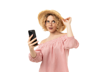Woman uses phone while adjusting hat, isolated on white, PNG