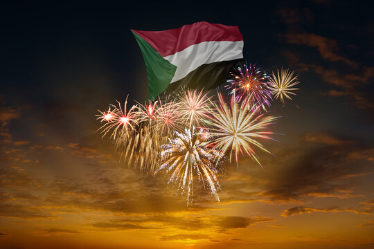 Flag of Sudan and Holiday fireworks in sky