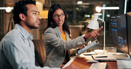 Night, pointing and business people on computer for finance review, investment and online trading. Meeting, working late and workers on tech for financial report, research and stock market in office