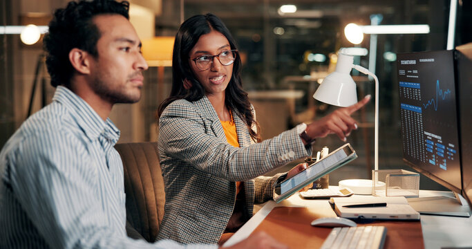 Night, pointing and business people on computer for finance review, investment and online trading. Meeting, working late and workers on tech for financial report, research and stock market in office