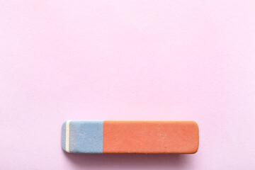 School eraser on lilac background