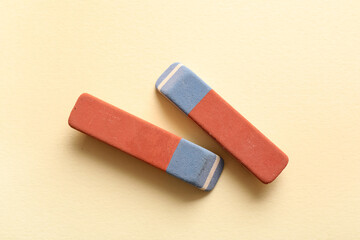 School erasers on light yellow background