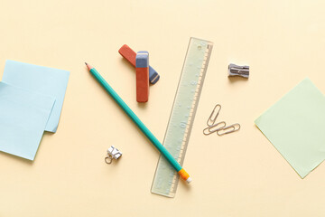 Erasers with stationery on light yellow background