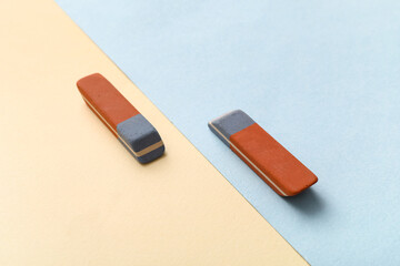 School erasers on color background