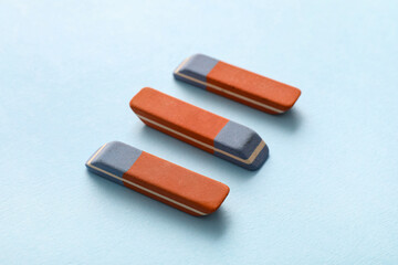 School erasers on blue background