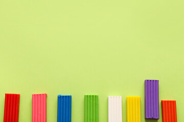 Colorful plasticine on green background